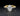 Gold ring with a large diamond and smaller diamonds on a reflective surface