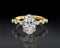 Gold ring with a large diamond and smaller diamonds on a reflective surface