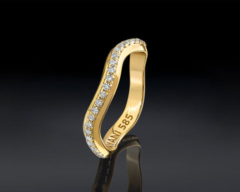 Gold ring with diamonds on a black background