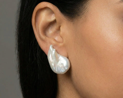 Pearl earring worn by a person with a neutral background