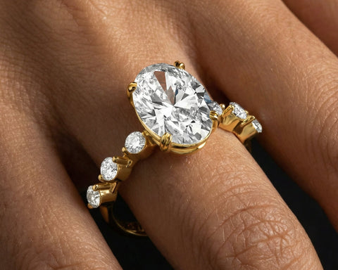 Gold ring with a large diamond on a person's finger