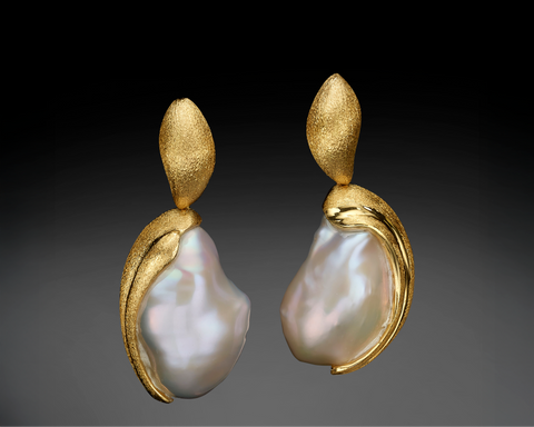 Pair of gold earrings with pearl drops on a gradient background