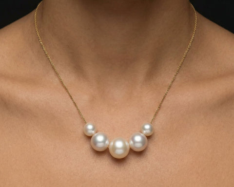 Pearl necklace on a person's neck against a dark background