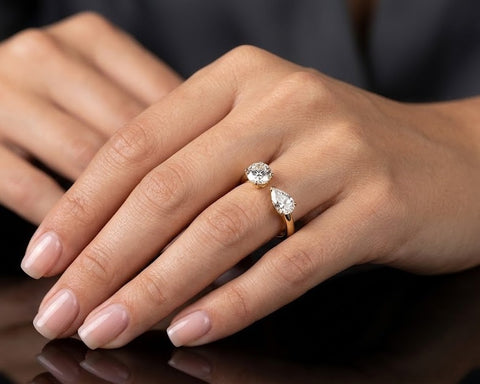 Aria open ring worn on hand, round and pear shaped diamonds