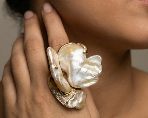 The Butterfly open ring worn on the hand, showing the scale of the three Keshi pearls