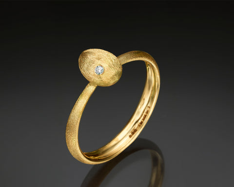 Small Cleaner Wrasse ring in 14K yellow gold, a hollow brushed fish form with an off-center bezel set diamond