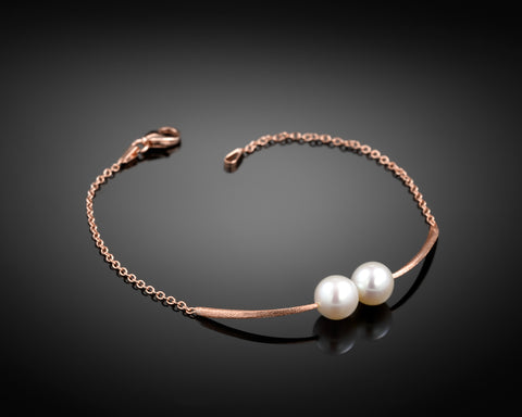 Cross Paths bracelet in rose gold with two round pearls