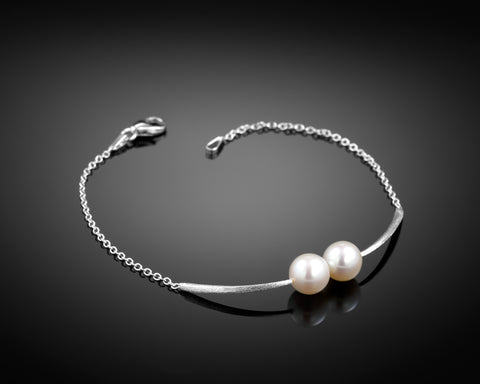 Cross Paths bracelet in white gold with two round pearls