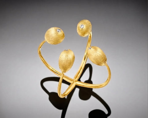 Crown of Thorns ring in yellow gold, two open bands crossing in an X, each end finished in a brushed nugget with a diamond