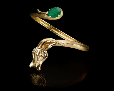 Handmade 18K gold dragon bracelet with an 8.6 carat Colombian emerald held in the dragon's tail and ruby set eyes