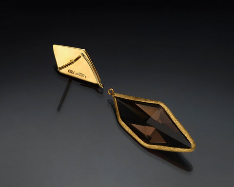 Close up of a single smoky quartz earring in 18K gold