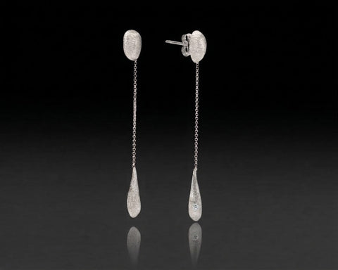 Flameback drop earrings in white gold with a diamond in each flame drop