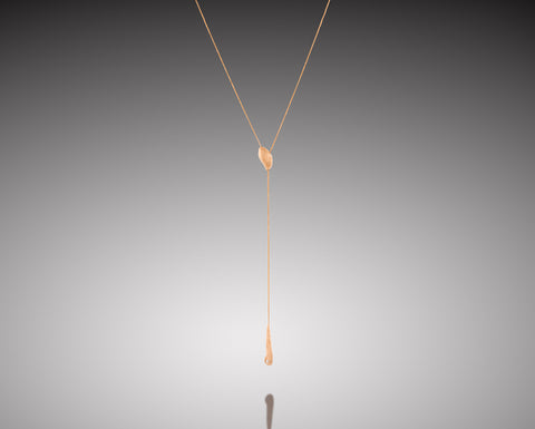 Flameback lariat necklace in white gold with a diamond flame drop