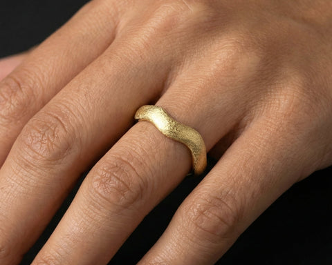 Golden Wave ring worn on the hand