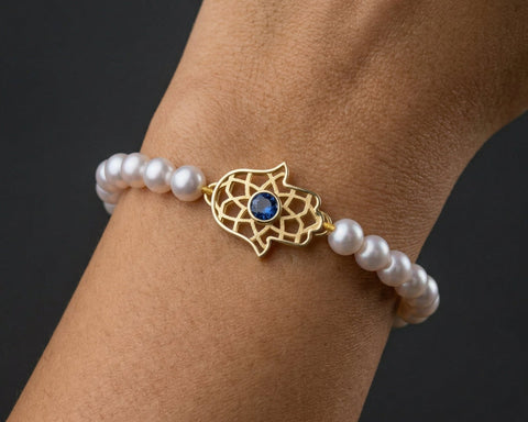 Hamsa pearl bracelet worn on the wrist