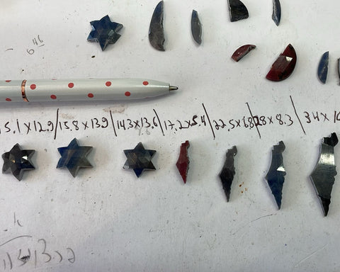 Sapphires I cut by hand into Stars of David and the outline of the Land of Israel, measured and laid out on the bench