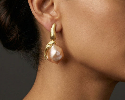 Handmade 18K gold earring with a natural Baroque Keshi pearl, worn on the ear