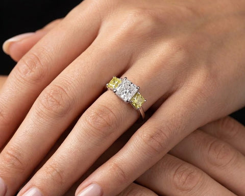 The Canary Trilogy ring worn on the hand, the yellow stones catching light on either side