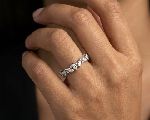 The Celestial Symphony eternity ring worn on the hand, marquise stones running along the finger