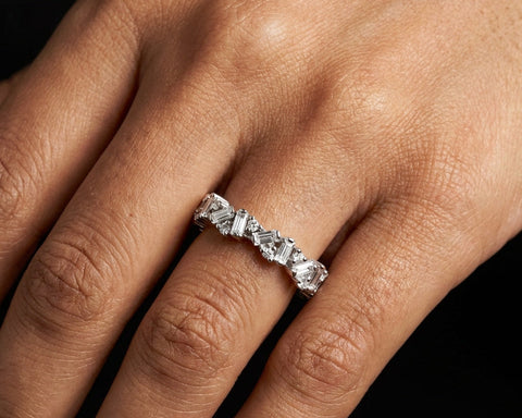 The Noi eternity ring worn on the hand, the angled baguettes catching light along the finger