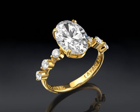 Side view of the yellow gold solitaire showing the setting and the shoulder stones