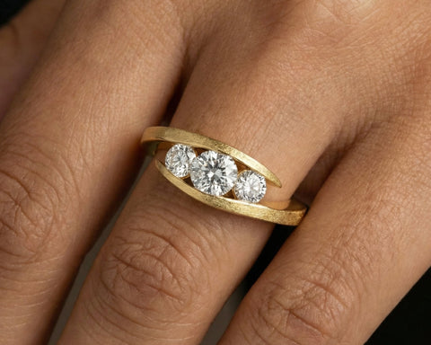 Liliane three-stone diamond ring worn on the hand