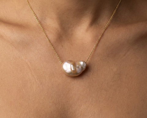 Moa Keshi pearl necklace worn at the base of the neck