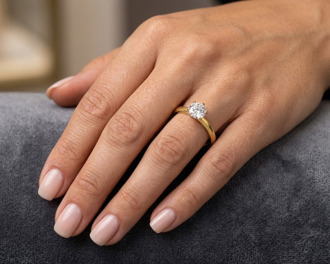 Noa round solitaire engagement ring worn on the hand