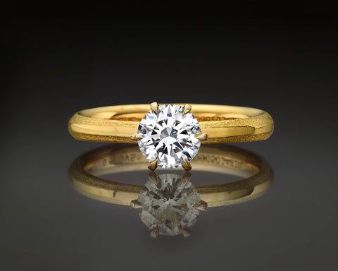 Noa round solitaire ring with a 0.70 carat GIA certified diamond in 18K yellow gold