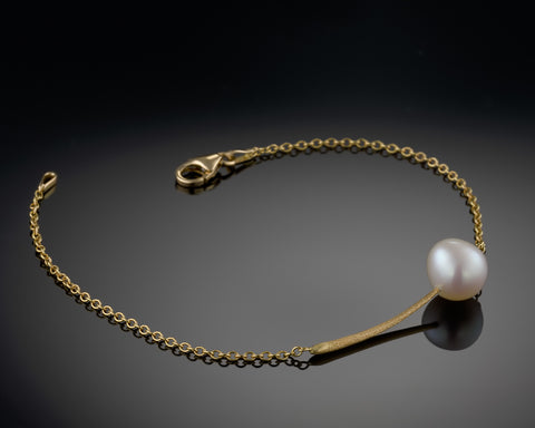 Nova bracelet in yellow gold shown open, with the clasp undone