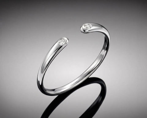 Ostracod open ring in white gold with a diamond at each end