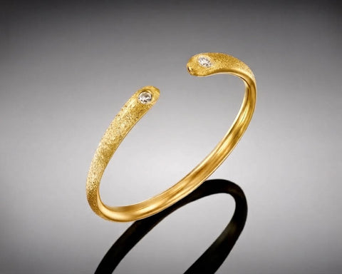 Ostracod open ring in yellow gold, a 1.5 mm brushed band with a small diamond at each end