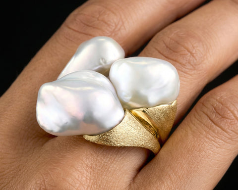 The Pebbles ring worn on the hand, showing the scale of the three Keshi pearls
