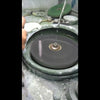 Grinding the underside of an amethyst on the water wheel, leaving the top untouched