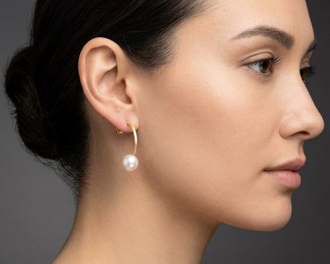 Reflection arc pearl earring worn on the ear