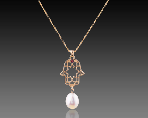 Rose gold hamsa pendant with a pearl swinging from the base