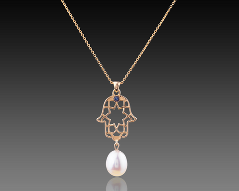 Rose gold hamsa pendant with a sapphire at the center and a pearl below