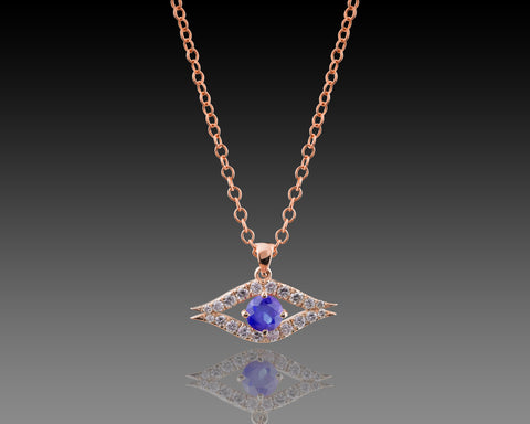 Rose gold guardian eye pendant with a blue sapphire center stone
