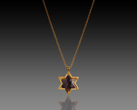 Sapphire hand cut into a Star of David, set in three layers of rose gold