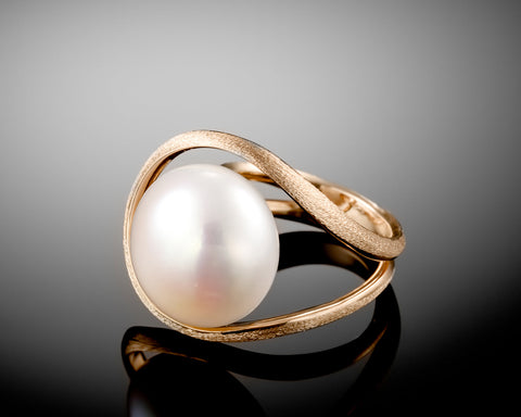 Handmade 18K rose gold ring with a white bouton pearl floating in an open circle