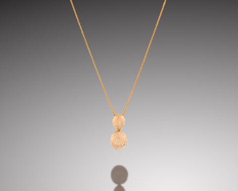 Sand Dollar pendant in rose gold with two brushed nuggets and a diamond
