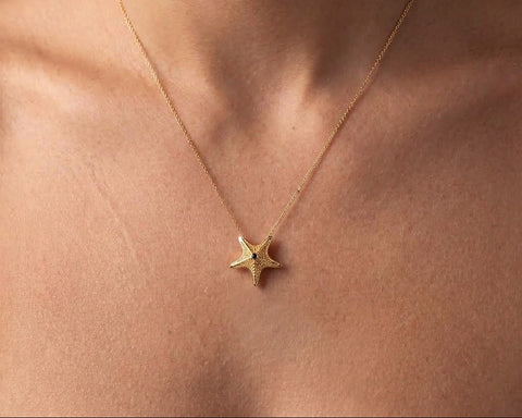 Starfish pendant in gold worn at the neck