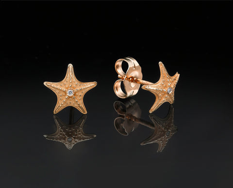 Starfish stud earrings in rose gold with granulated texture and a diamond at the center