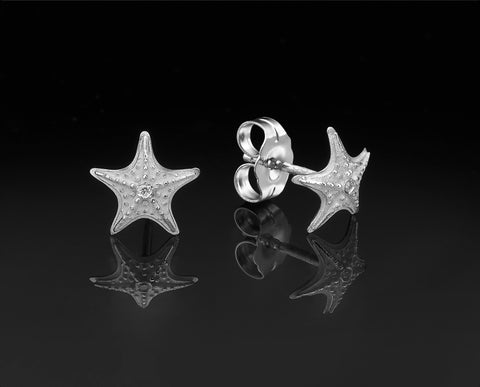 Starfish stud earrings in white gold with granulated texture and a diamond at the center