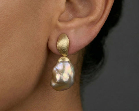 The Sunset Keshi pearl earring worn on the ear as a full drop