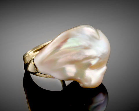 Side view of the Whale ring showing the gold extending the line of the pearl