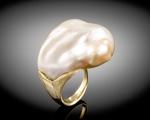 The Whale ring seen from another angle, showing the rough and polished gold finish