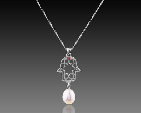 White gold hamsa pendant with a pearl swinging from the base