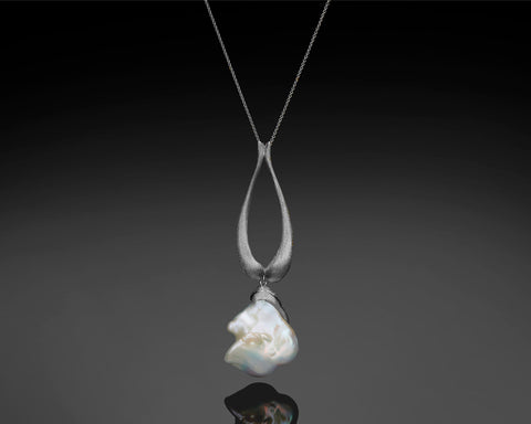 Handmade 14K white gold teardrop pendant with a large white baroque pearl