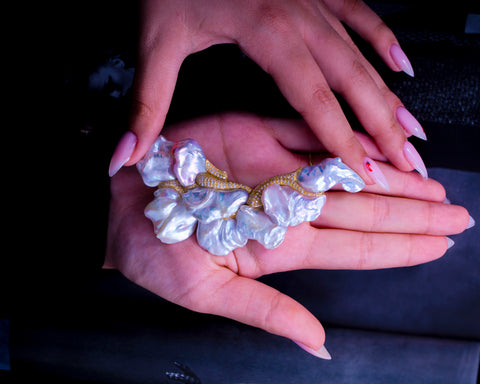The Wild Horse brooch held in the hand, showing its full 105 x 54 mm scale